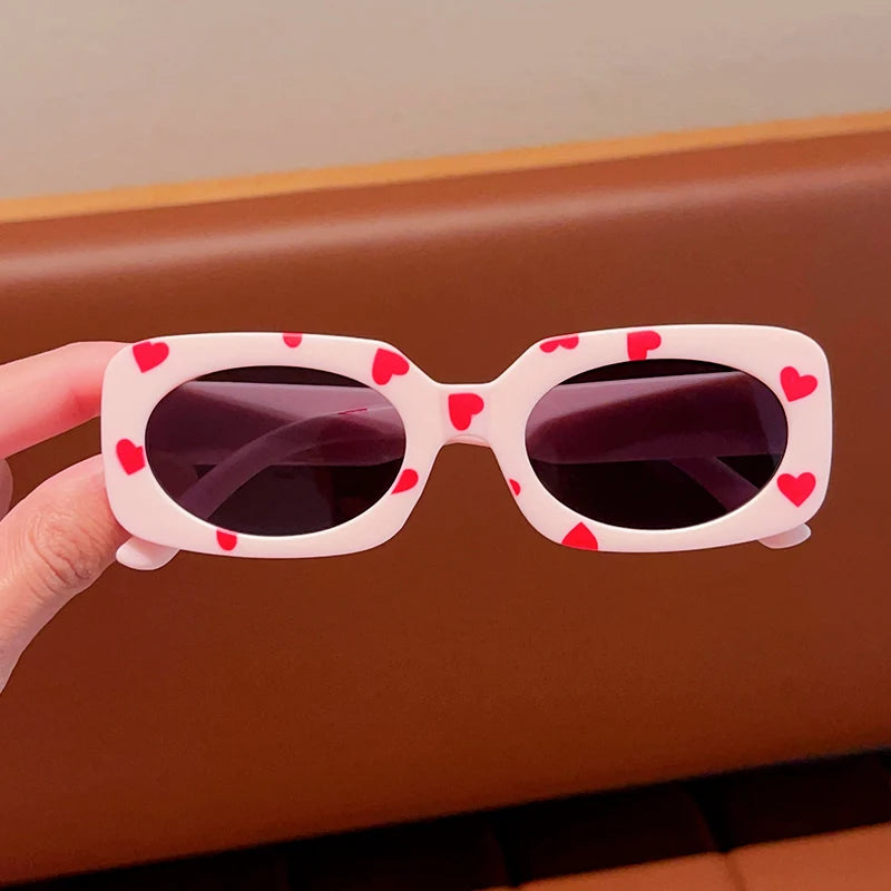 kids heart-shaped sunglasses, rectangular polarised eyewear, UV400 kids glasses, girls’ vintage sunglasses, trendy kids sun protection, outdoor kids eyewear, stylish wrap sunglasses, lightweight child sun shades, polycarbonate sunglasses for kids, glare-reducing eyewear