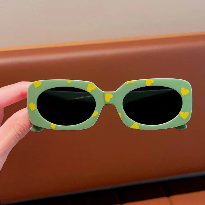 kids heart-shaped sunglasses, rectangular polarised eyewear, UV400 kids glasses, girls’ vintage sunglasses, trendy kids sun protection, outdoor kids eyewear, stylish wrap sunglasses, lightweight child sun shades, polycarbonate sunglasses for kids, glare-reducing eyewear