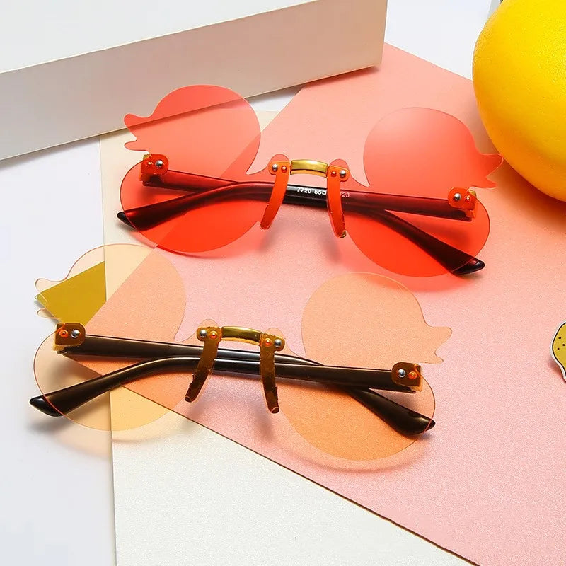 duck-shaped sunglasses, kids rimless eyewear, UV400 kids sunglasses, cartoon duck glasses, boys' fun sunglasses, anti-reflective sunglasses for kids, lightweight polycarbonate frames, kids decorative party glasses, playful sun protection, stylish children’s eyewear