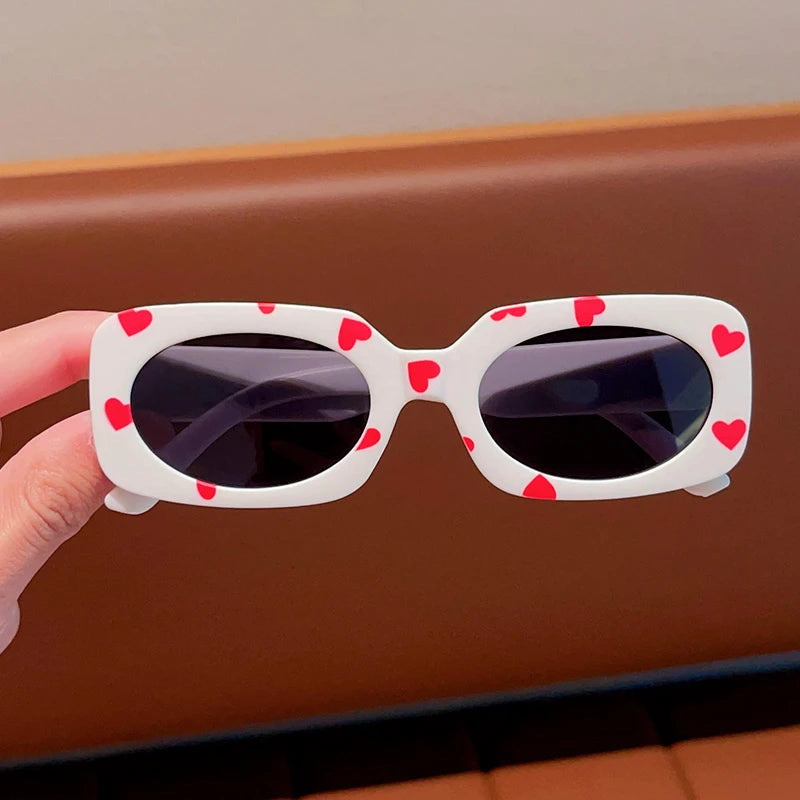kids heart-shaped sunglasses, rectangular polarised eyewear, UV400 kids glasses, girls’ vintage sunglasses, trendy kids sun protection, outdoor kids eyewear, stylish wrap sunglasses, lightweight child sun shades, polycarbonate sunglasses for kids, glare-reducing eyewear