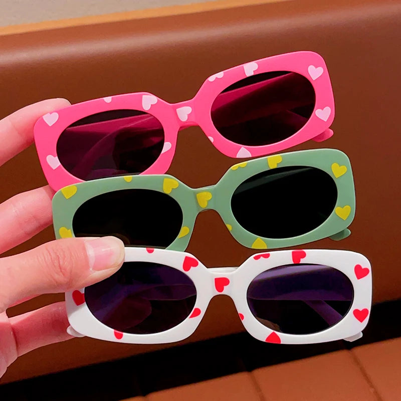 kids heart-shaped sunglasses, rectangular polarised eyewear, UV400 kids glasses, girls’ vintage sunglasses, trendy kids sun protection, outdoor kids eyewear, stylish wrap sunglasses, lightweight child sun shades, polycarbonate sunglasses for kids, glare-reducing eyewear
