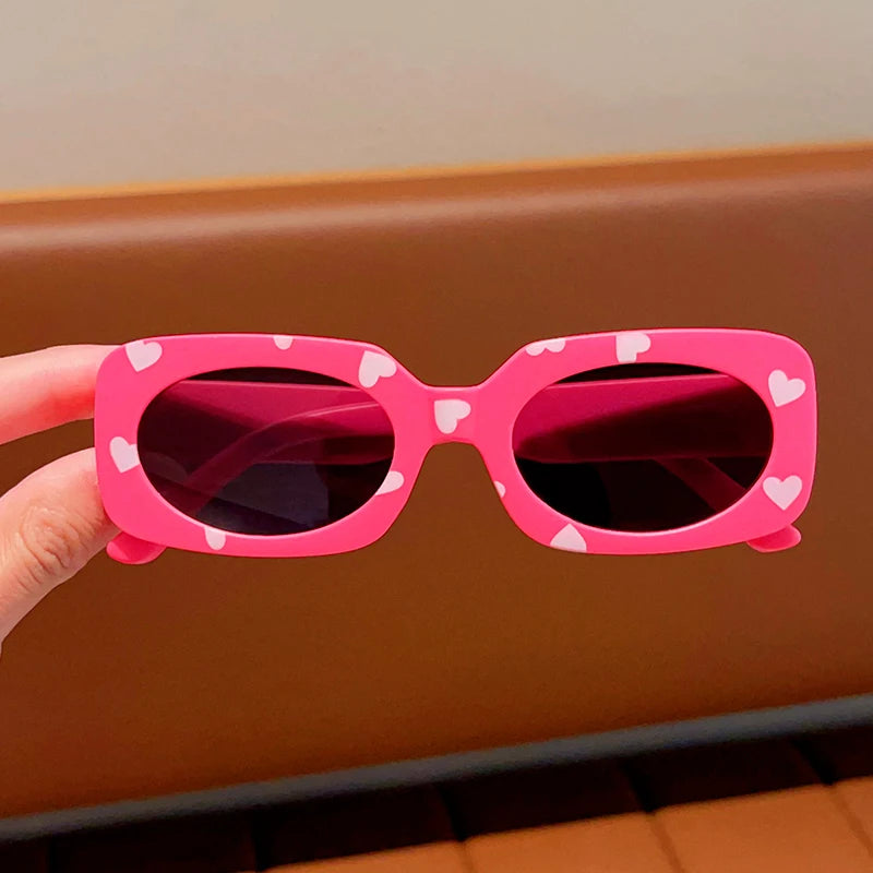 kids heart-shaped sunglasses, rectangular polarised eyewear, UV400 kids glasses, girls’ vintage sunglasses, trendy kids sun protection, outdoor kids eyewear, stylish wrap sunglasses, lightweight child sun shades, polycarbonate sunglasses for kids, glare-reducing eyewear