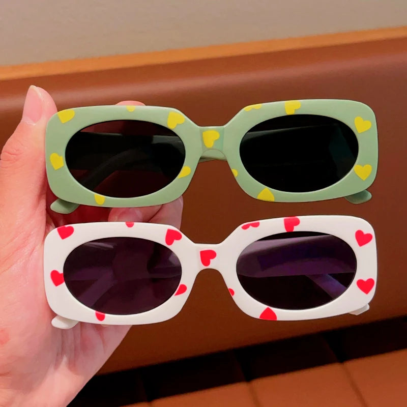 kids heart-shaped sunglasses, rectangular polarised eyewear, UV400 kids glasses, girls’ vintage sunglasses, trendy kids sun protection, outdoor kids eyewear, stylish wrap sunglasses, lightweight child sun shades, polycarbonate sunglasses for kids, glare-reducing eyewear