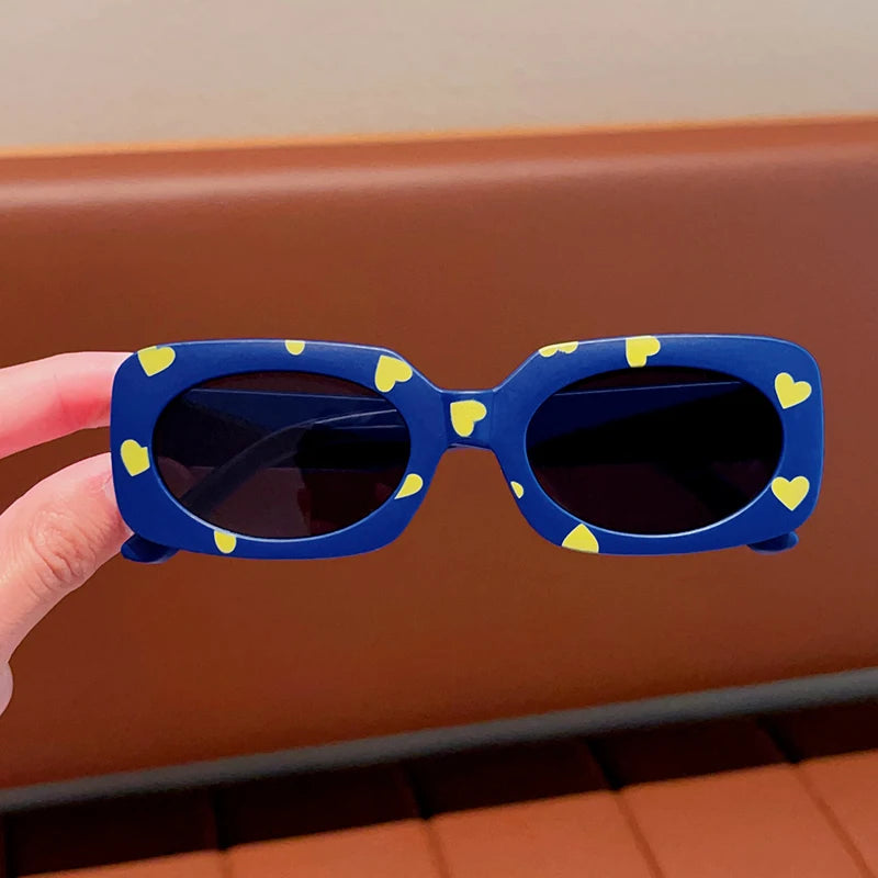 kids heart-shaped sunglasses, rectangular polarised eyewear, UV400 kids glasses, girls’ vintage sunglasses, trendy kids sun protection, outdoor kids eyewear, stylish wrap sunglasses, lightweight child sun shades, polycarbonate sunglasses for kids, glare-reducing eyewear